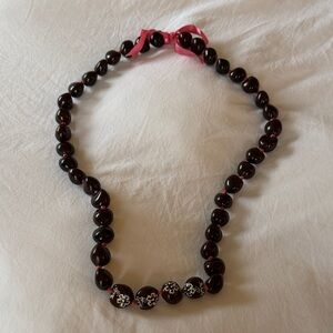 Elegant Black Beaded Necklace with Pink Ribbon